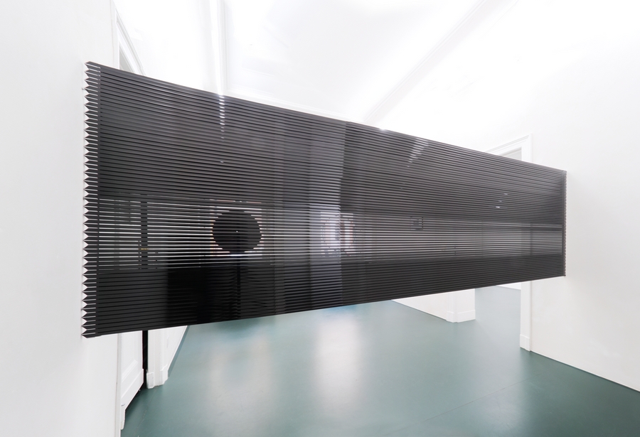 Blind Screen, 2013. Video tape, aluminium profiles, 99.25 x 335.5 x 2 cm. Two single holes, 2013 [shining through].